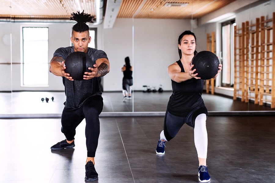 a couple performing exercise on how to lose weight without losing muscle